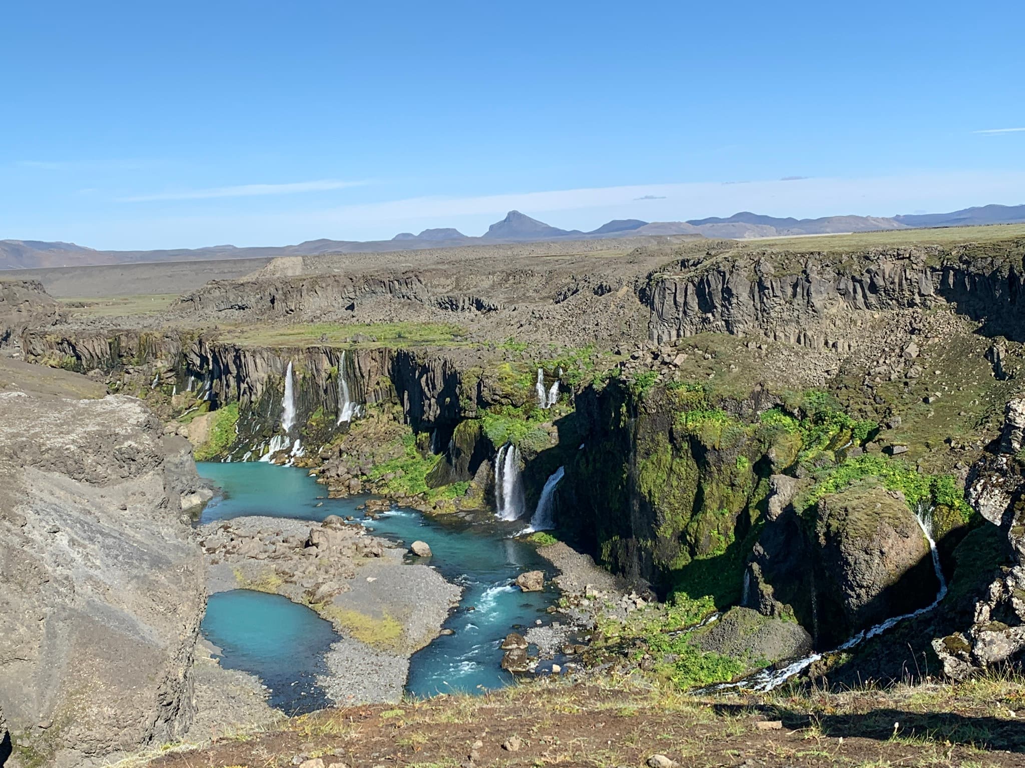 Waterfalls cascading into an Icelandic canyon