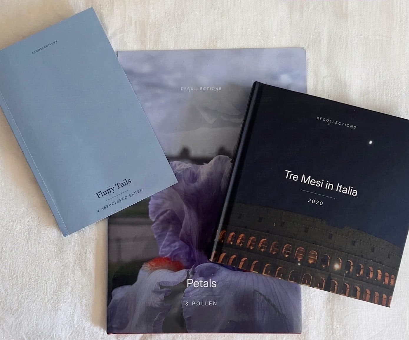 A softcover, a jacketed linen wrap and a hardcover photo book laid out together
